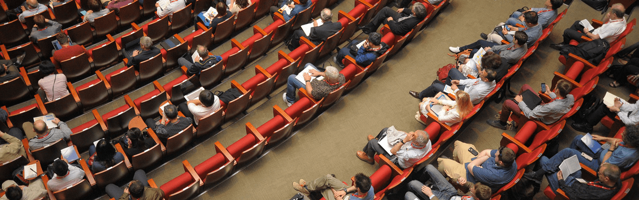 Teilnehmer eines Kongresses hören einem Vortrag zu.